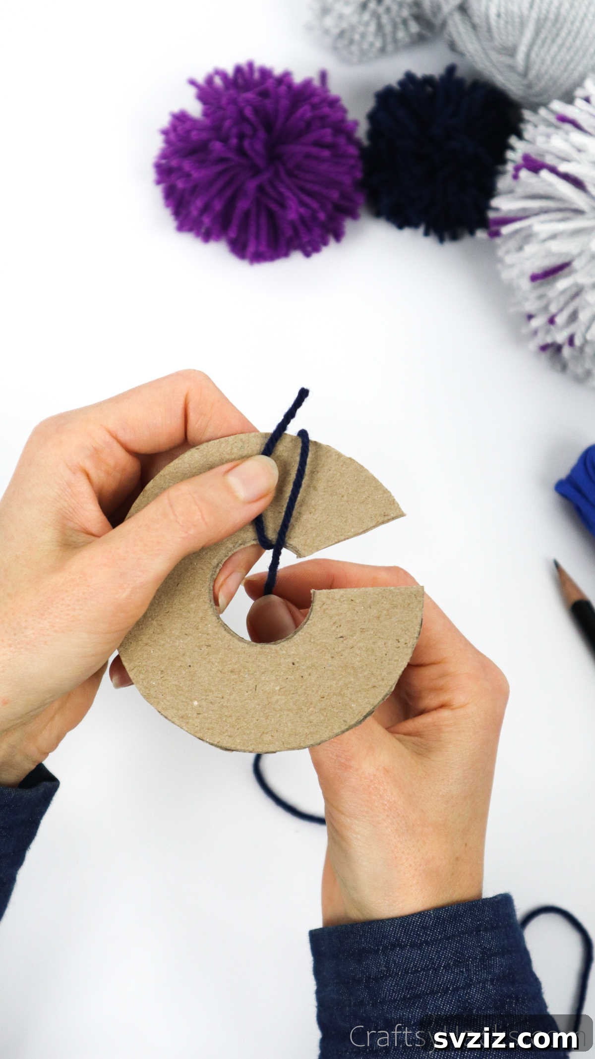 Continuously wrapping yarn around the cardboard disks, building layers