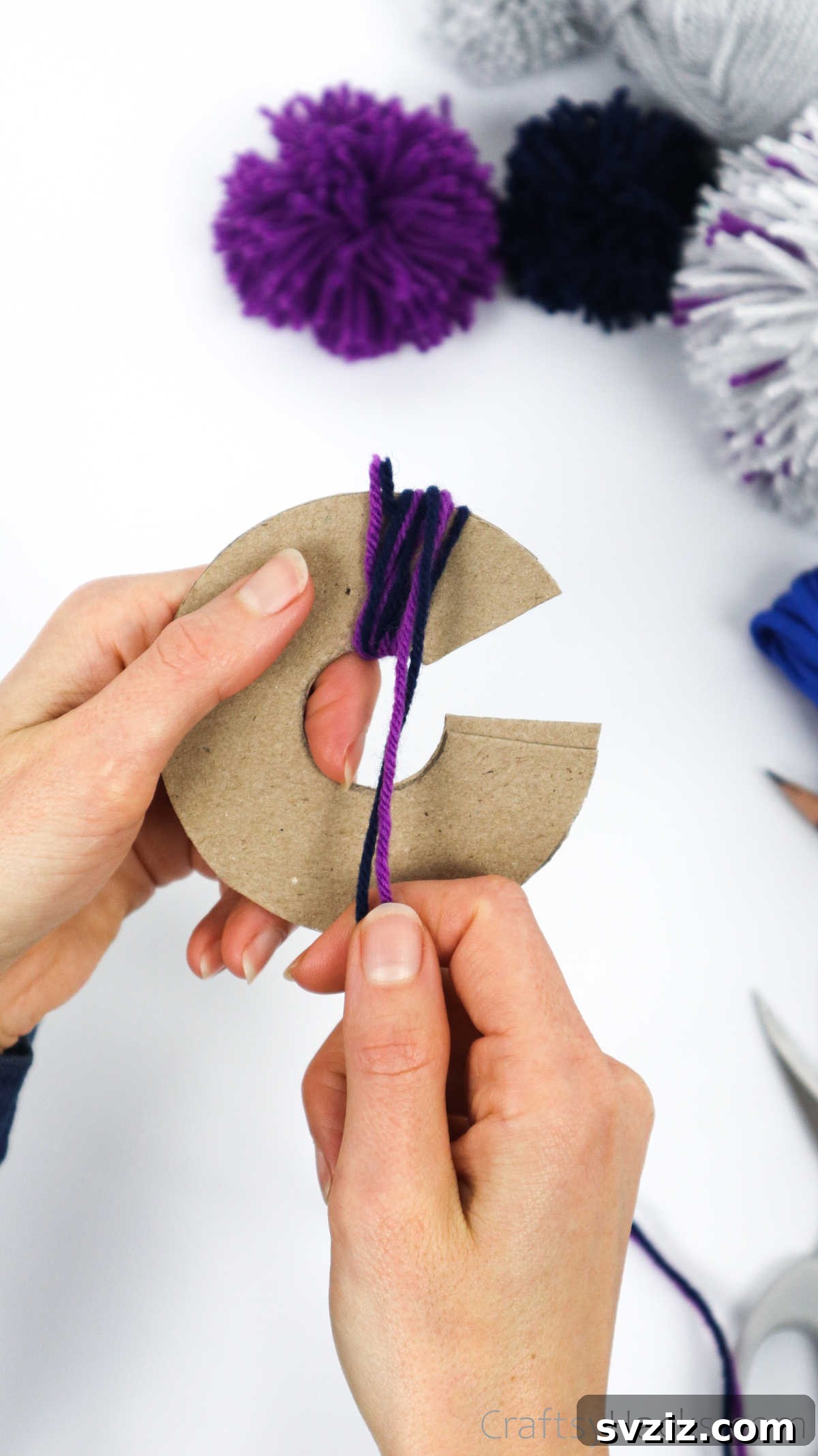The cardboard disks almost completely covered with wrapped yarn