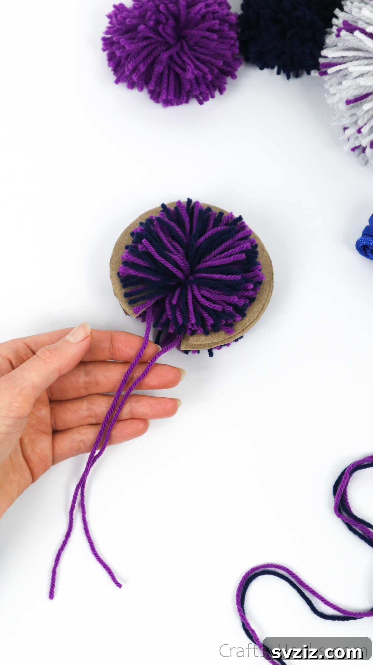 The tie-off yarn threaded through the center of the disks