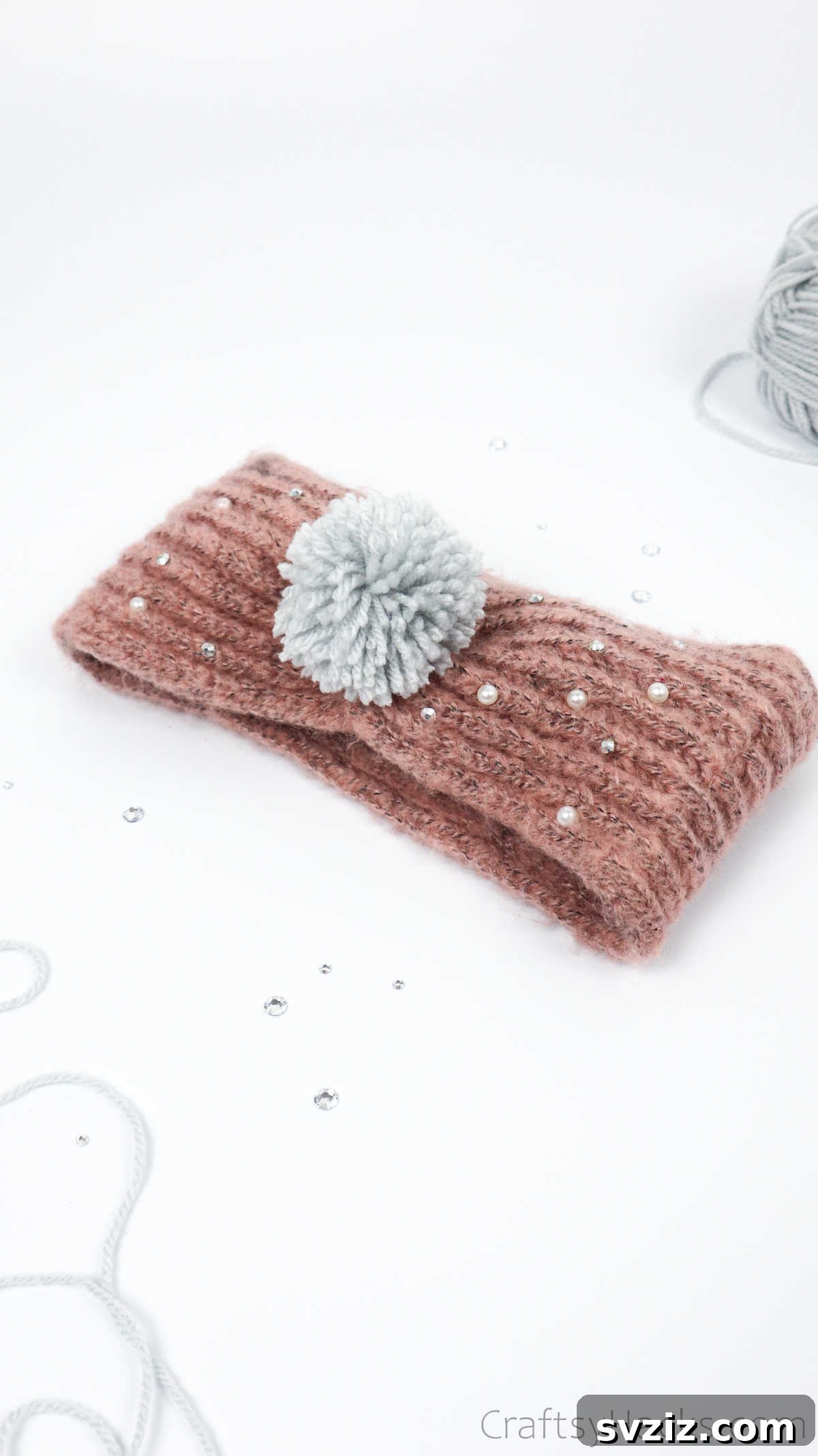 Stylish headband decorated with a bright yellow yarn pom pom