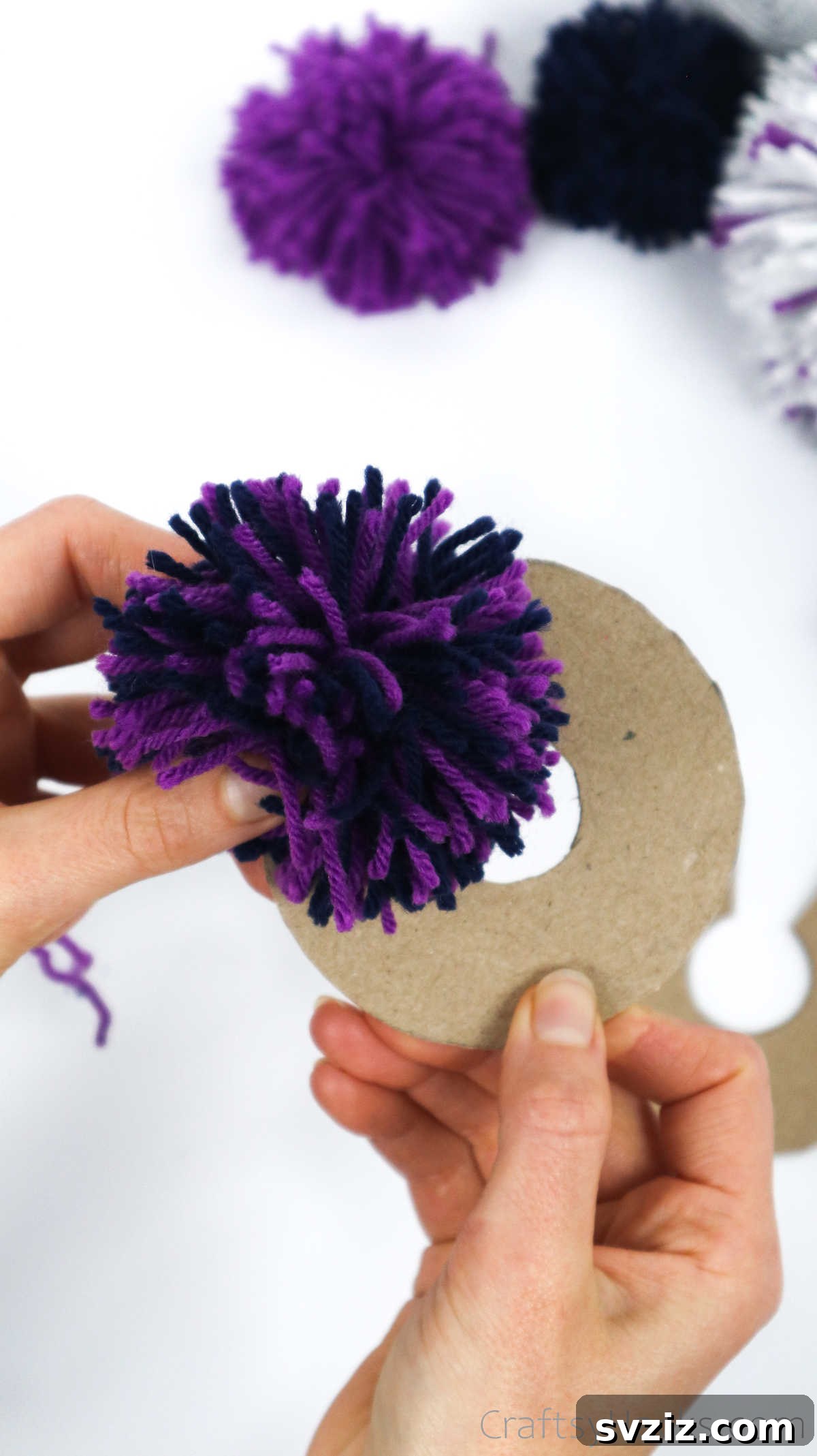 A newly formed yarn pom pom after removing the cardboard disks