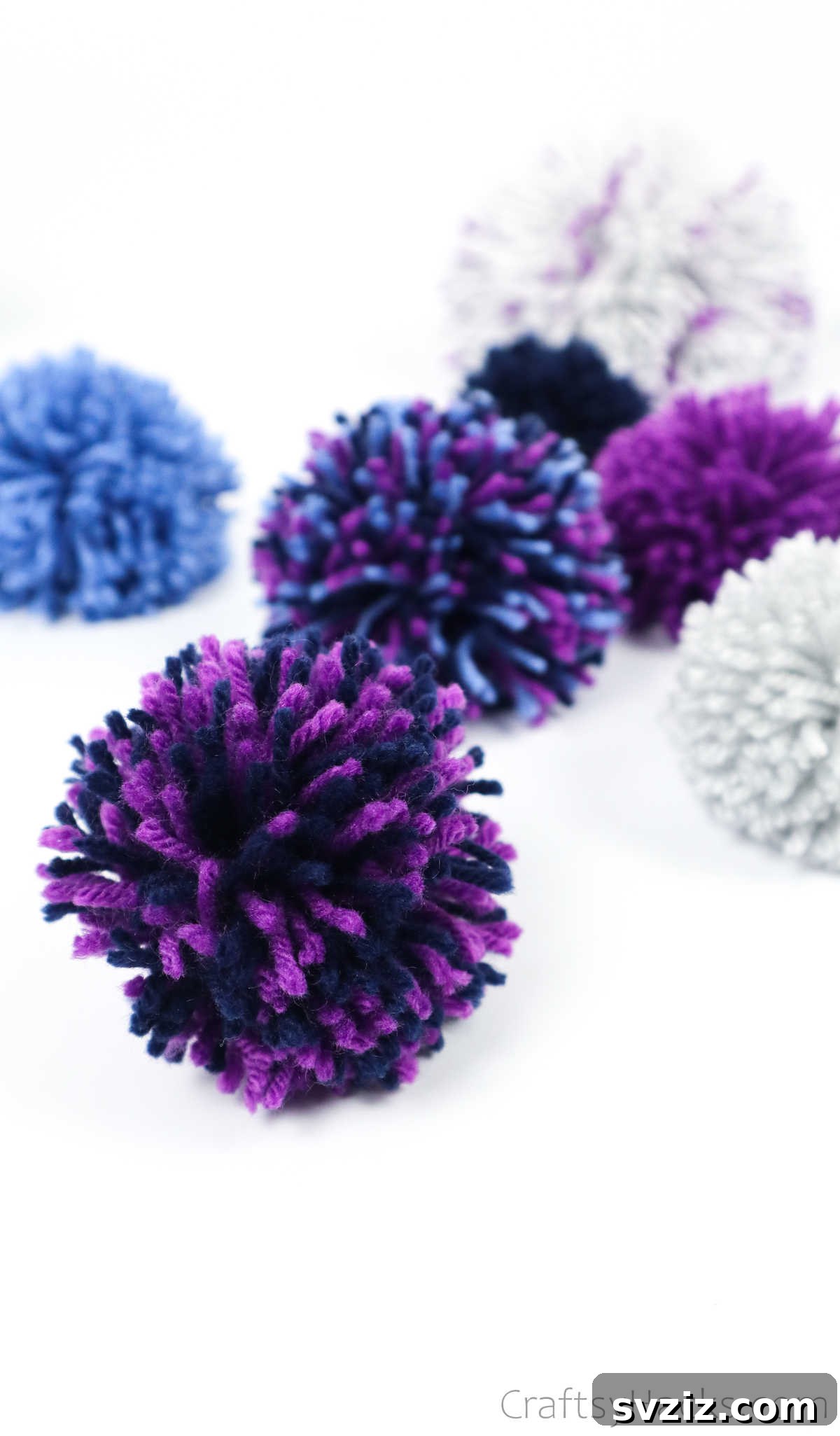 A single fluffy purple yarn pom pom, showcasing its texture