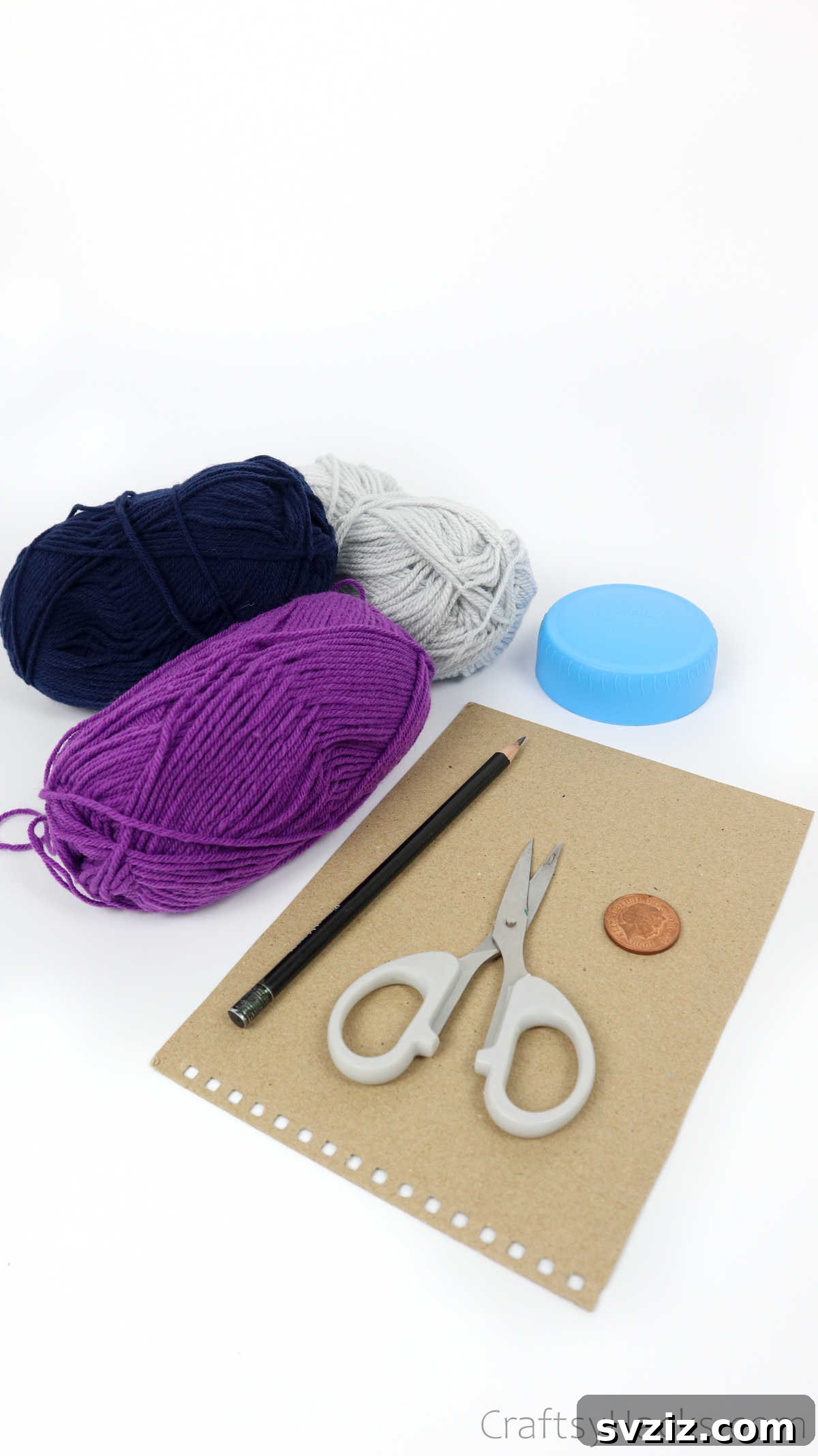 Collection of yarn and craft supplies for making pom poms