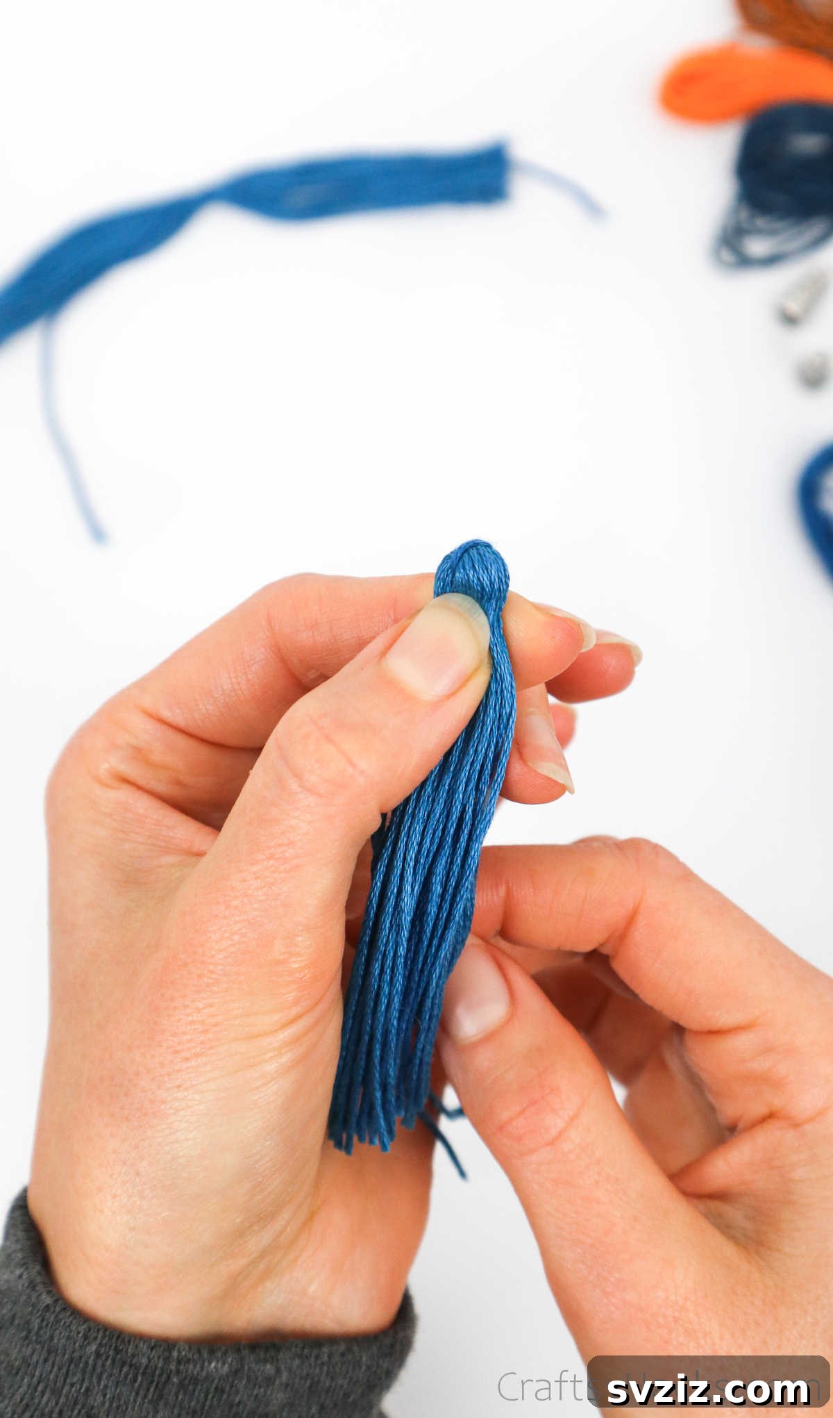 Craft Your Own Trendy Tassel Earrings 15 holding end of thread