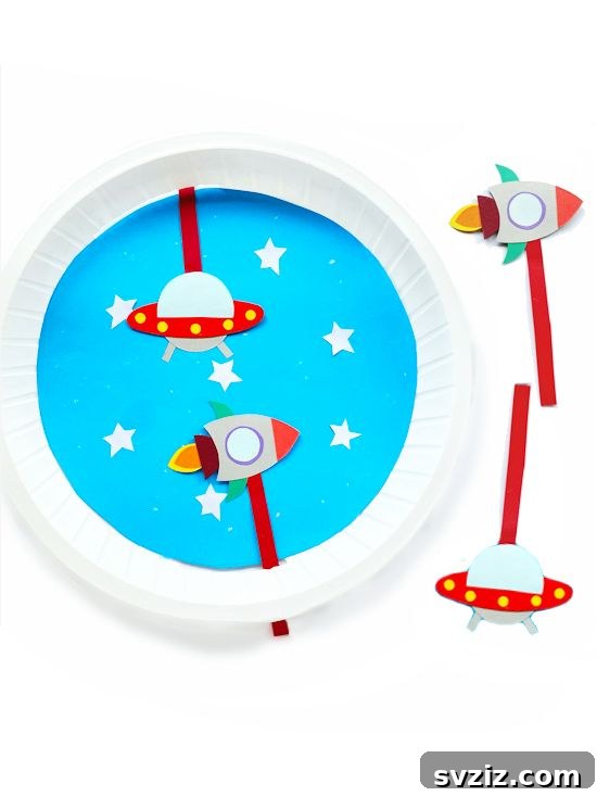Crafting Smiles: Paper Plate Fun for Kids 12 Dynamic paper plate space scene craft featuring rockets, planets, and stars against a dark background.