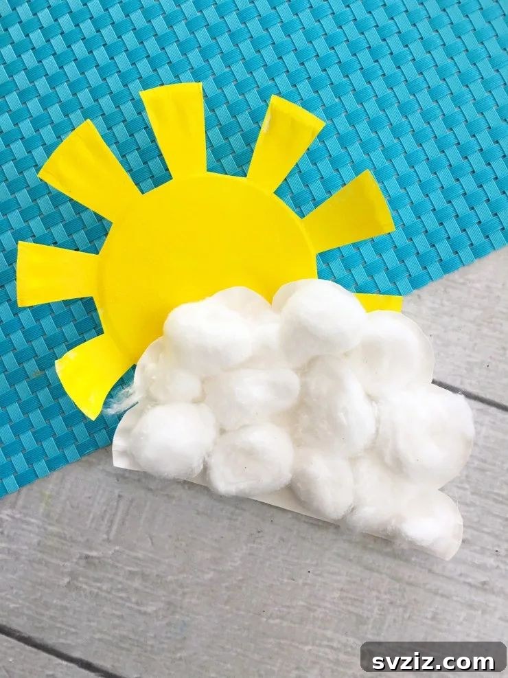 Crafting Smiles: Paper Plate Fun for Kids 16 Sunny paper plate craft featuring a smiling sun emerging from a fluffy cotton ball cloud.