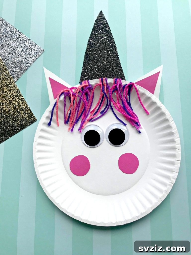 Crafting Smiles: Paper Plate Fun for Kids 17 Sparkling paper plate unicorn craft with a rainbow mane and golden horn, exuding magic and positivity.