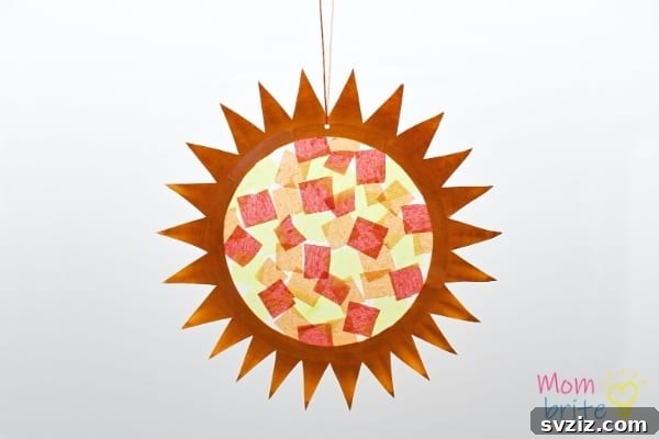 Crafting Smiles: Paper Plate Fun for Kids 27 Colorful paper plate suncatcher craft with translucent tissue paper creating a stained-glass effect.