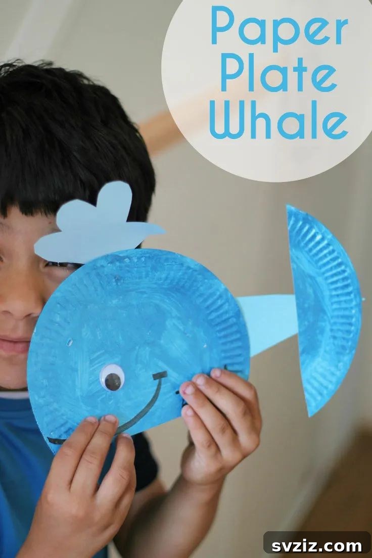 Crafting Smiles: Paper Plate Fun for Kids 30 Large blue paper plate whale craft with a googly eye and a water spout, celebrating ocean life.