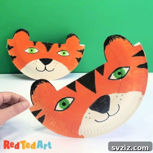 Crafting Smiles: Paper Plate Fun for Kids 33 Vibrant paper plate tiger craft with black stripes, orange base, and expressive facial features.