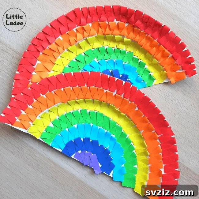 Crafting Smiles: Paper Plate Fun for Kids 34 Bright and colorful paper plate rainbow craft with a cloud at each end, ideal for teaching colors.