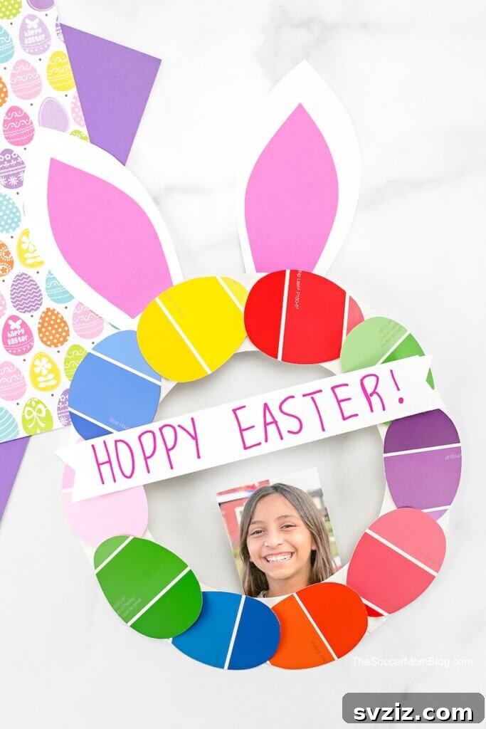Crafting Smiles: Paper Plate Fun for Kids 39 Festive paper plate Easter bunny wreath adorned with colorful eggs and a sweet 'Hoppy Easter' message.