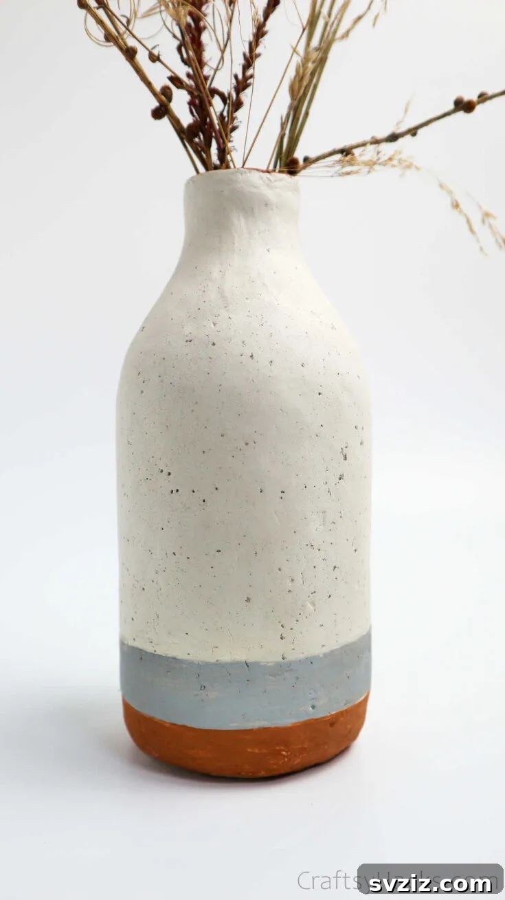 51 Heartfelt DIY Gifts for Their New Beginning 5 Handcrafted Bottle Vase with textured clay design