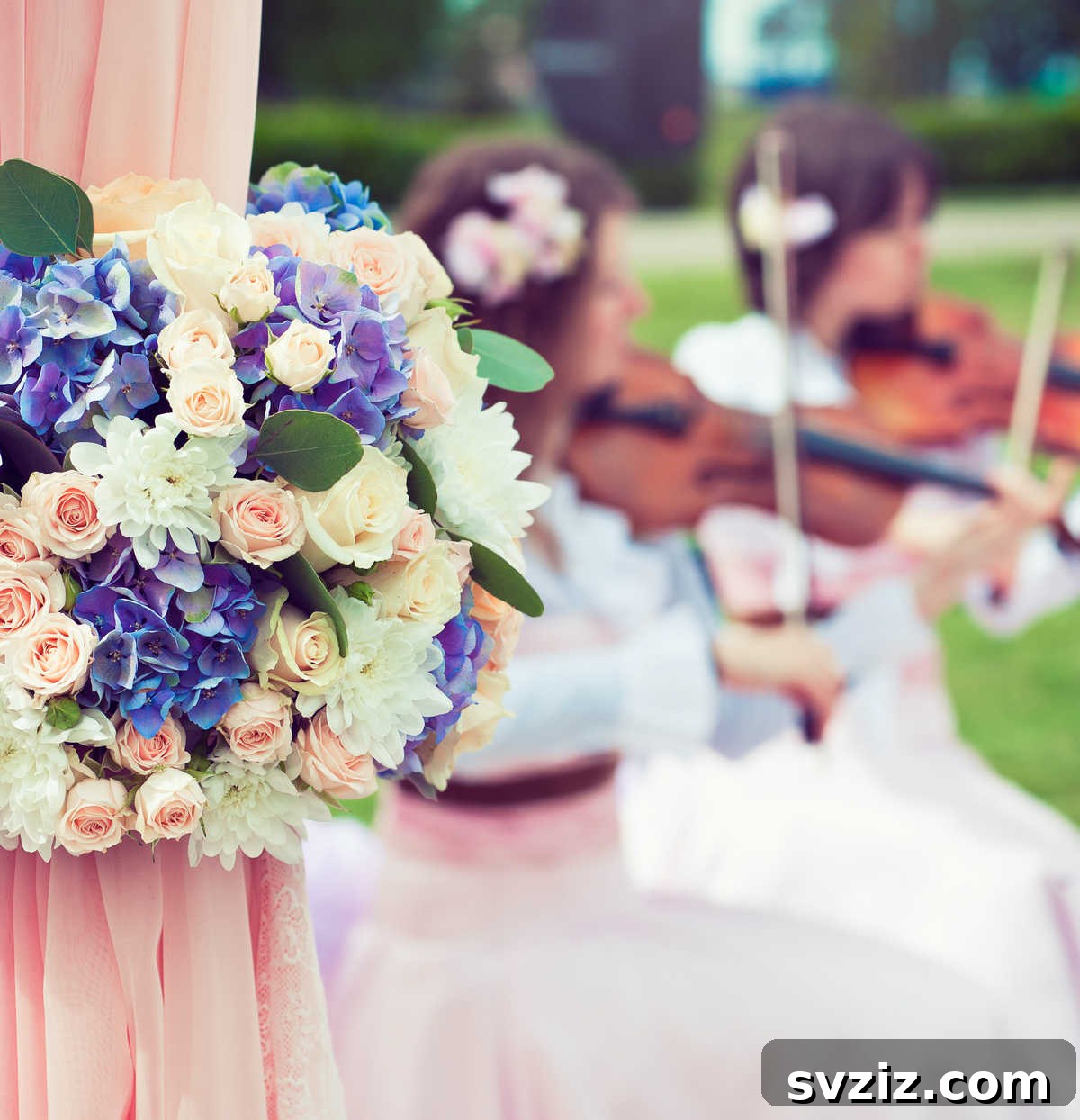 A wedding couple walking through an aisle formed by musicians playing instruments