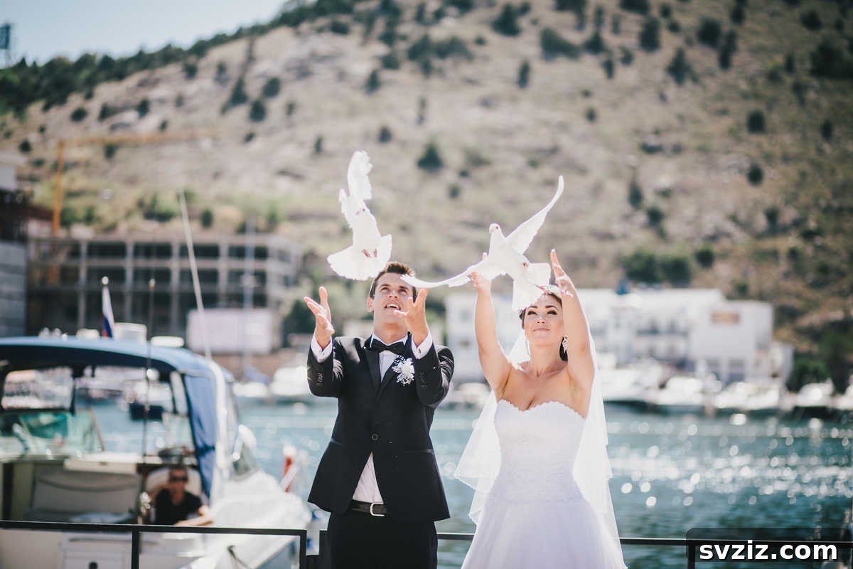 A pair of white doves being released during a wedding send-off