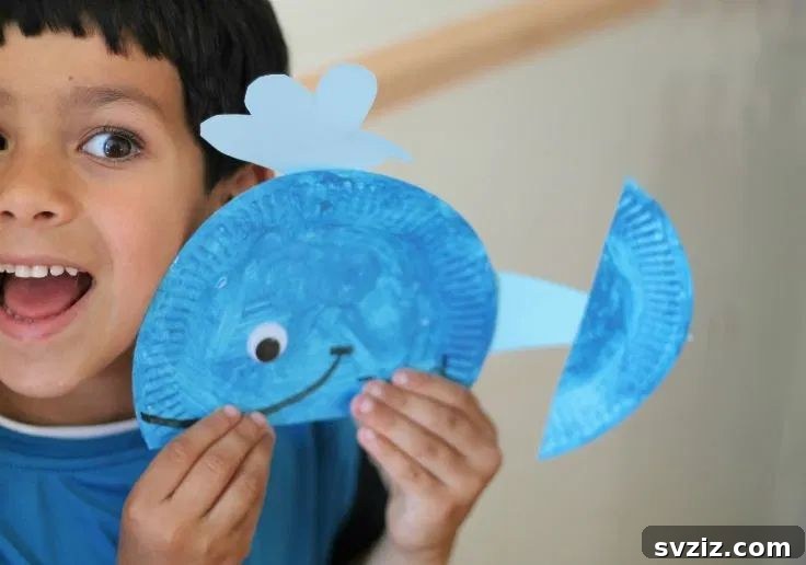 A charming paper plate whale craft with googly eyes and water spout, perfect for ocean-themed activities.