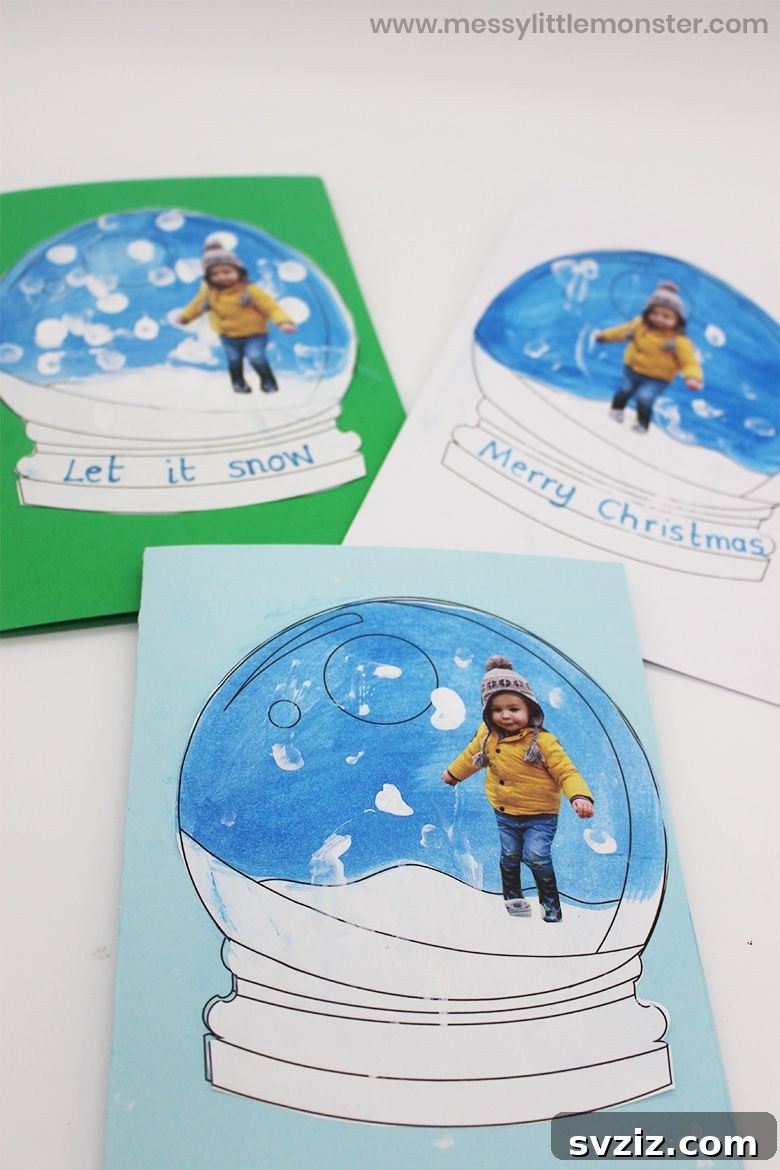 A festive DIY snow globe card with a child's photo and cotton swab snow details, perfect for Christmas.