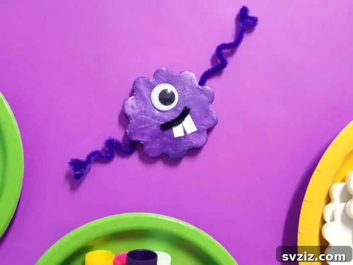 Colorful monster magnets made from painted and shaped dough, a fun craft for birthdays or classroom activities.
