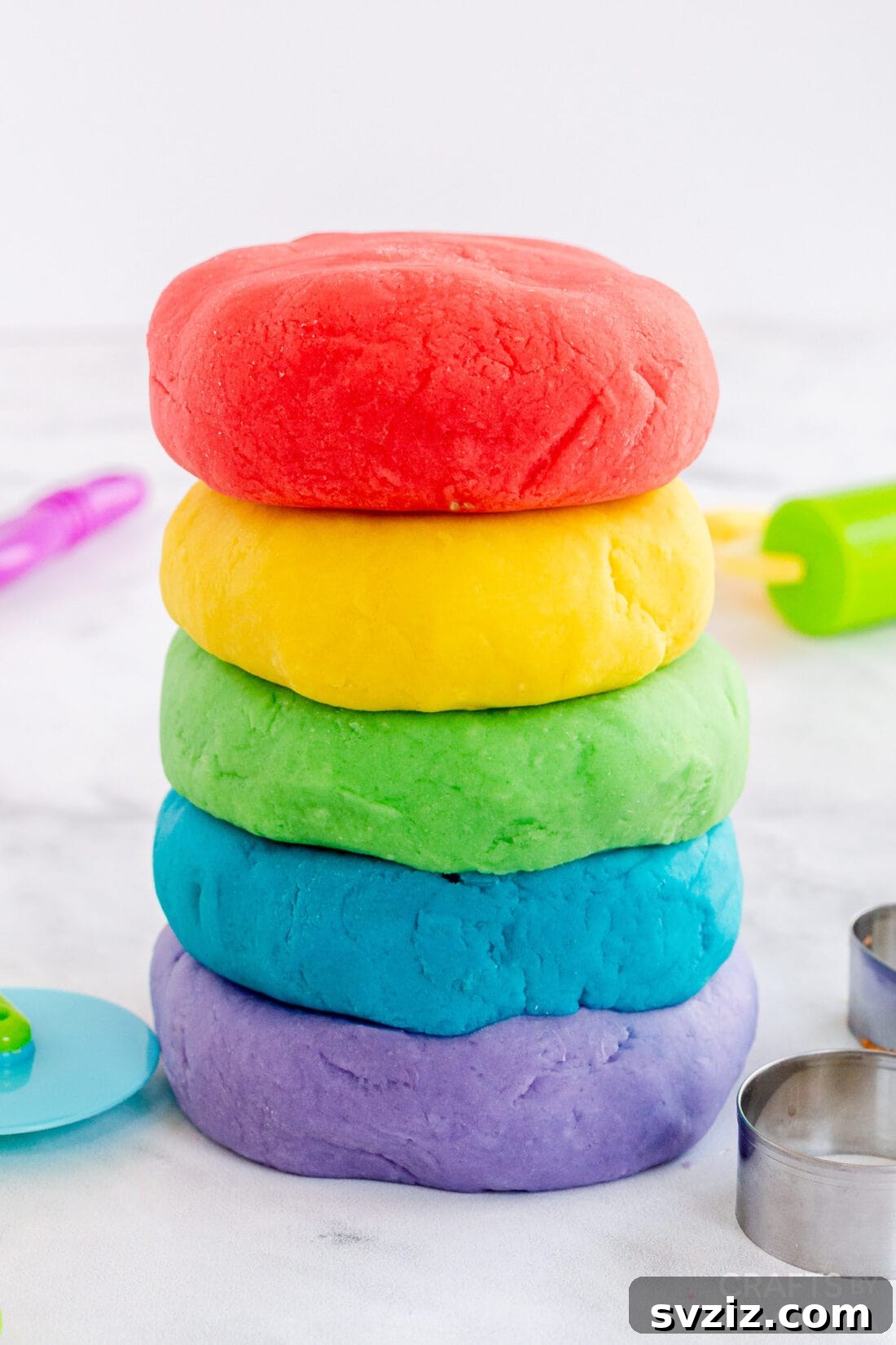 A batch of colorful homemade playdough in various hues, perfect for sensory and imaginative play.
