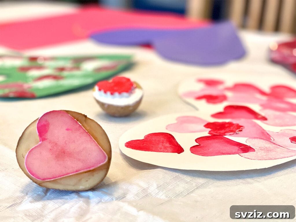 Heart-shaped potato stamps creating colorful art on paper, a simple and reusable craft for kids.