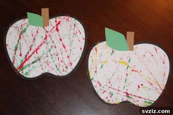A vibrant marble-painted apple craft, demonstrating movement and color mixing for preschoolers.