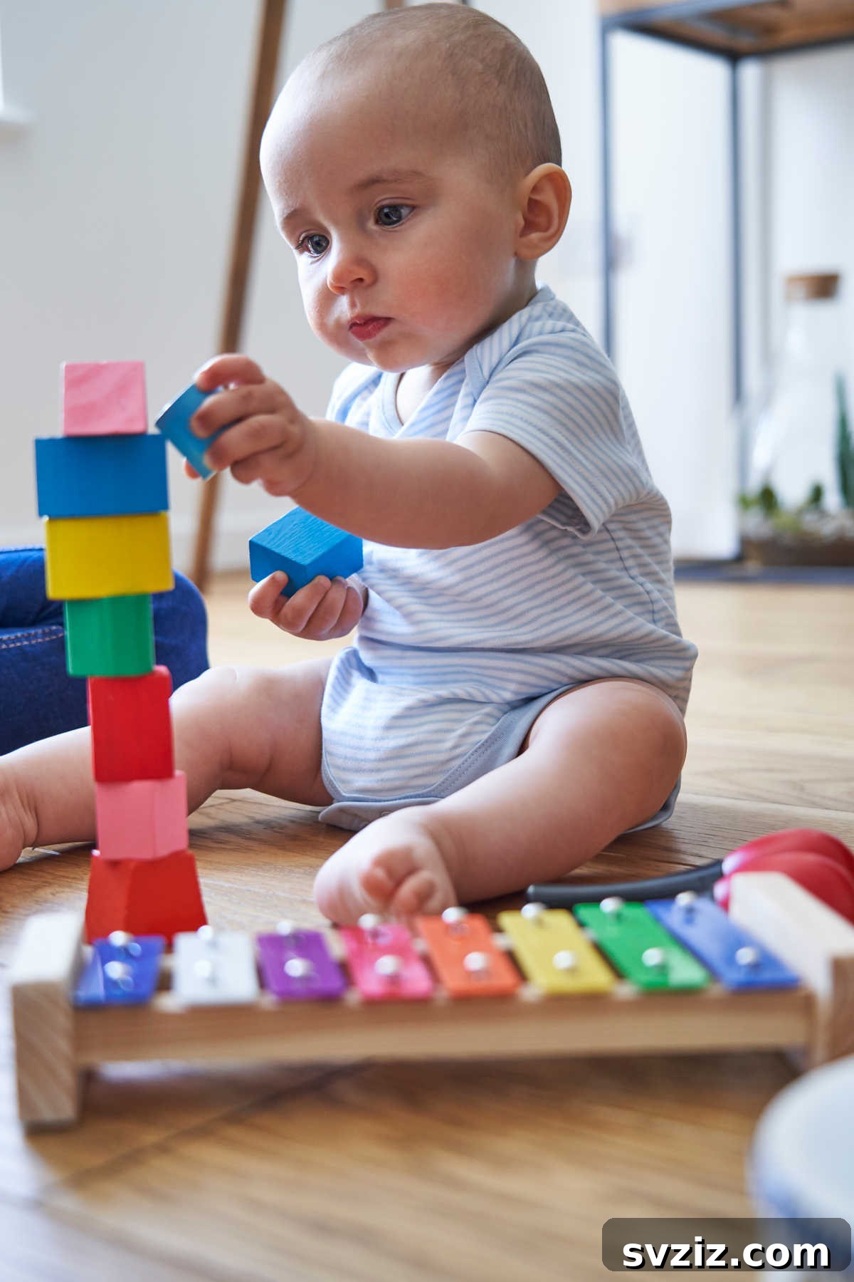 Toddler stacking colorful rings, an activity for fine motor skills.