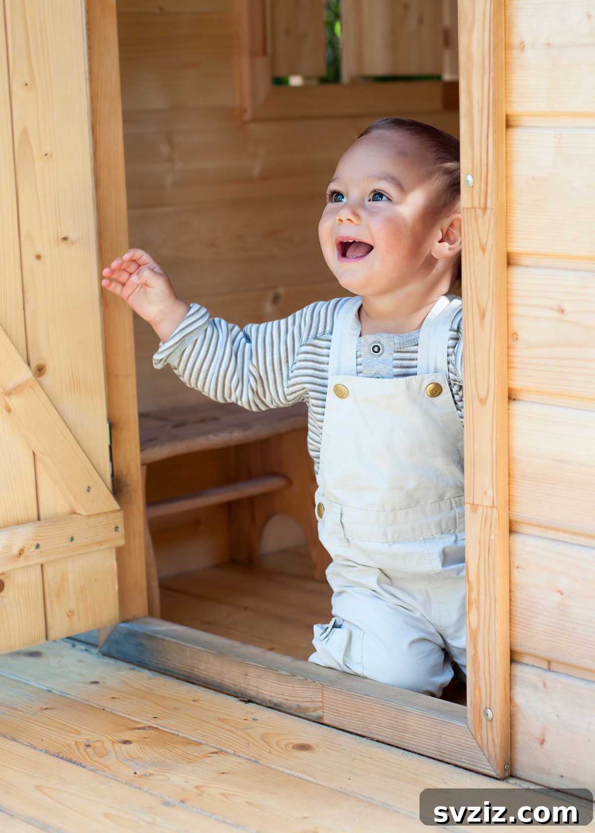 Toddler playing in a colorful playhouse, perfect for imaginative 1-year-old activities.
