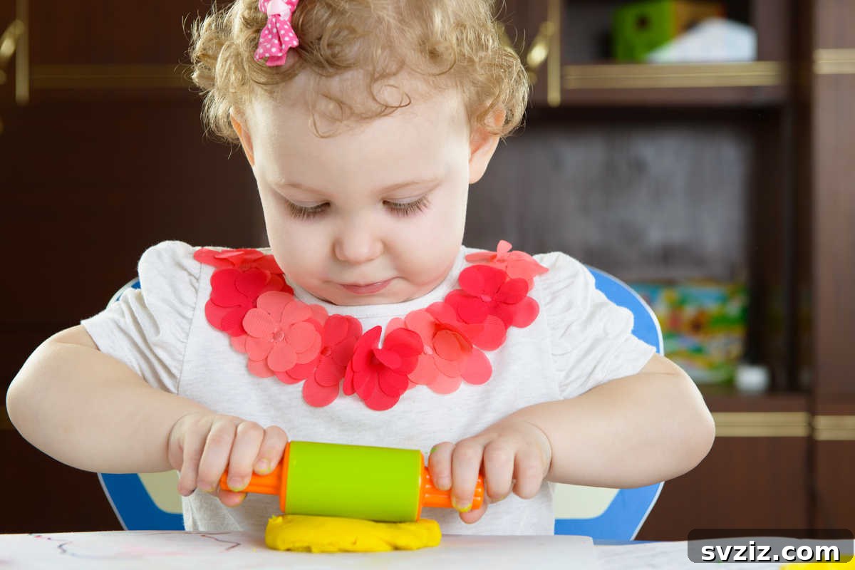 Toddler playing with colorful playdough, a creative activity for 1-year-olds.