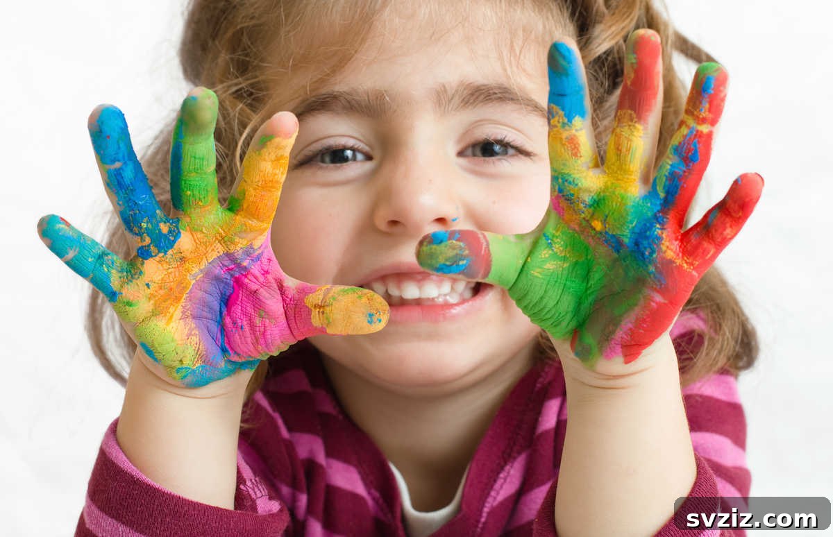 Baby enjoying finger painting, a messy but fun developmental activity.