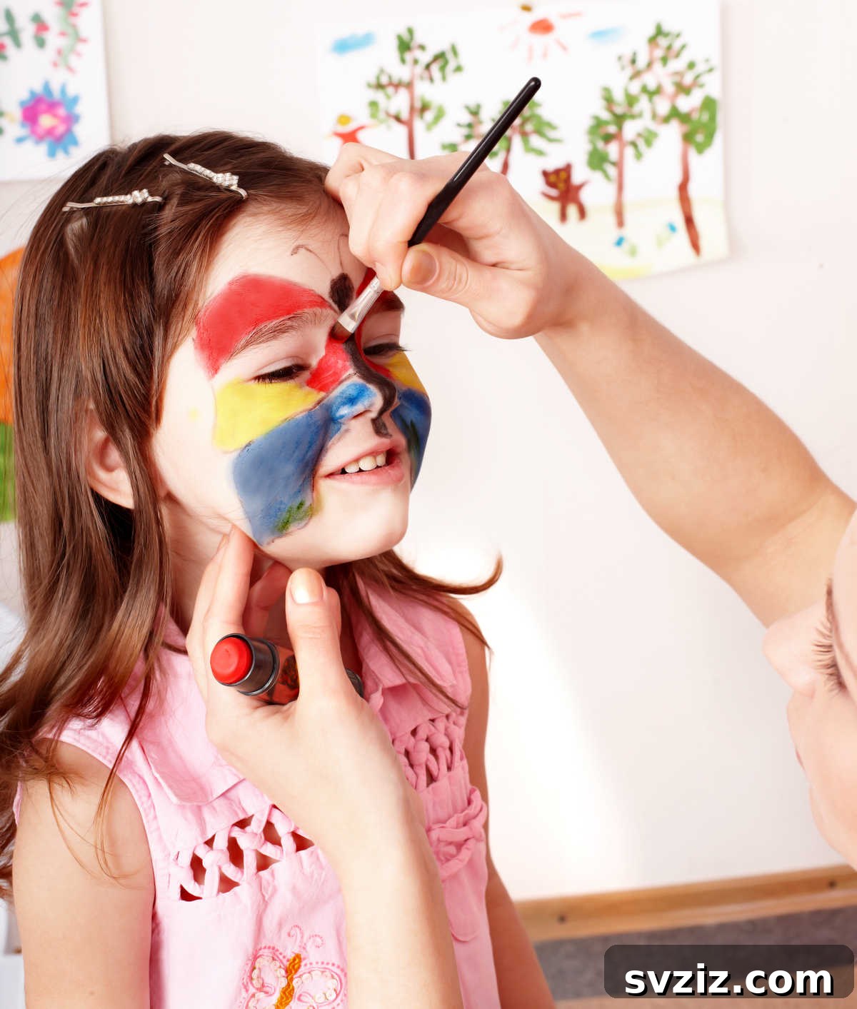 41 Creative Play Ideas for Two-Year-Olds 5 A child with a whimsical face paint design, smiling joyfully.