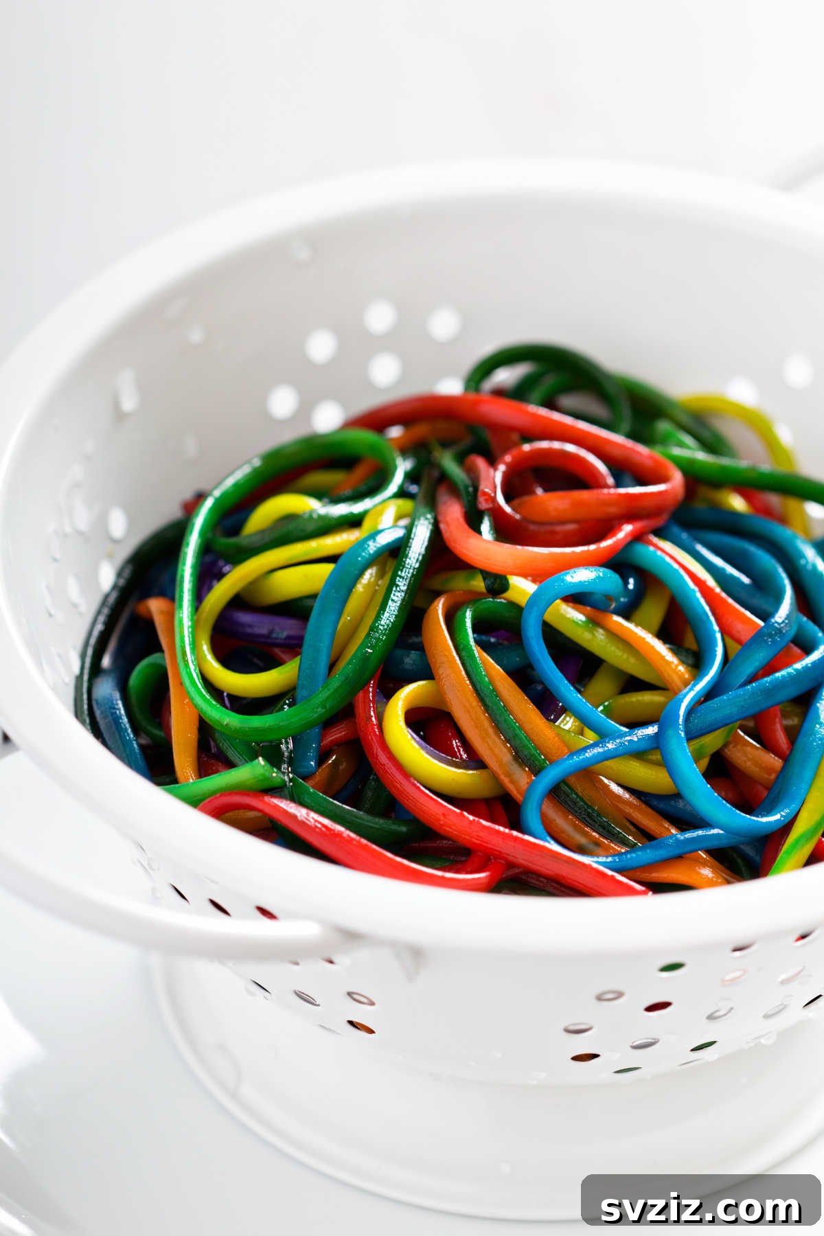 41 Creative Play Ideas for Two-Year-Olds 6 Colorful cooked pasta arranged for a tactile sensory play experience.