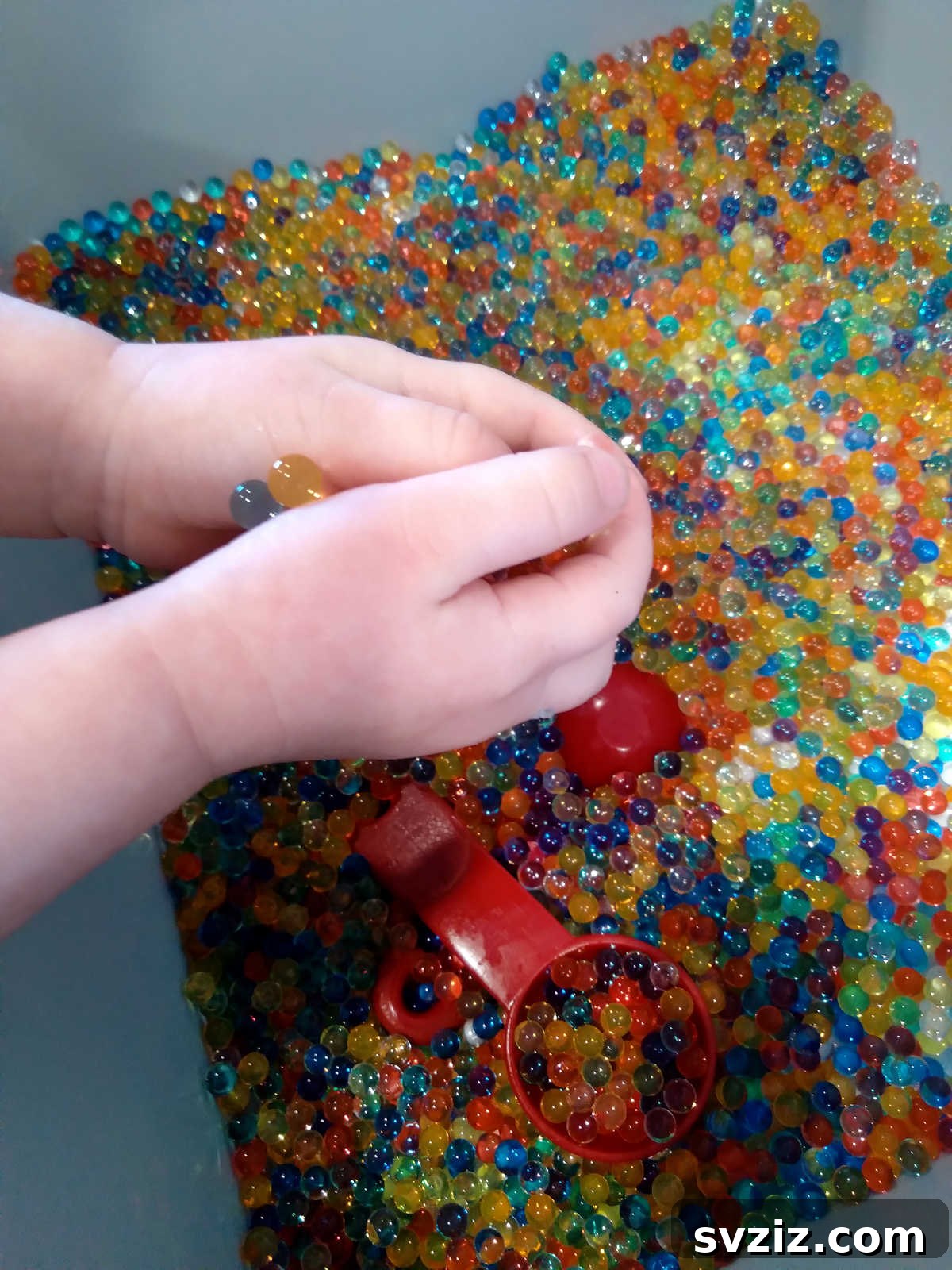 41 Creative Play Ideas for Two-Year-Olds 9 Frozen water beads in various colors, offering a unique sensory experience.