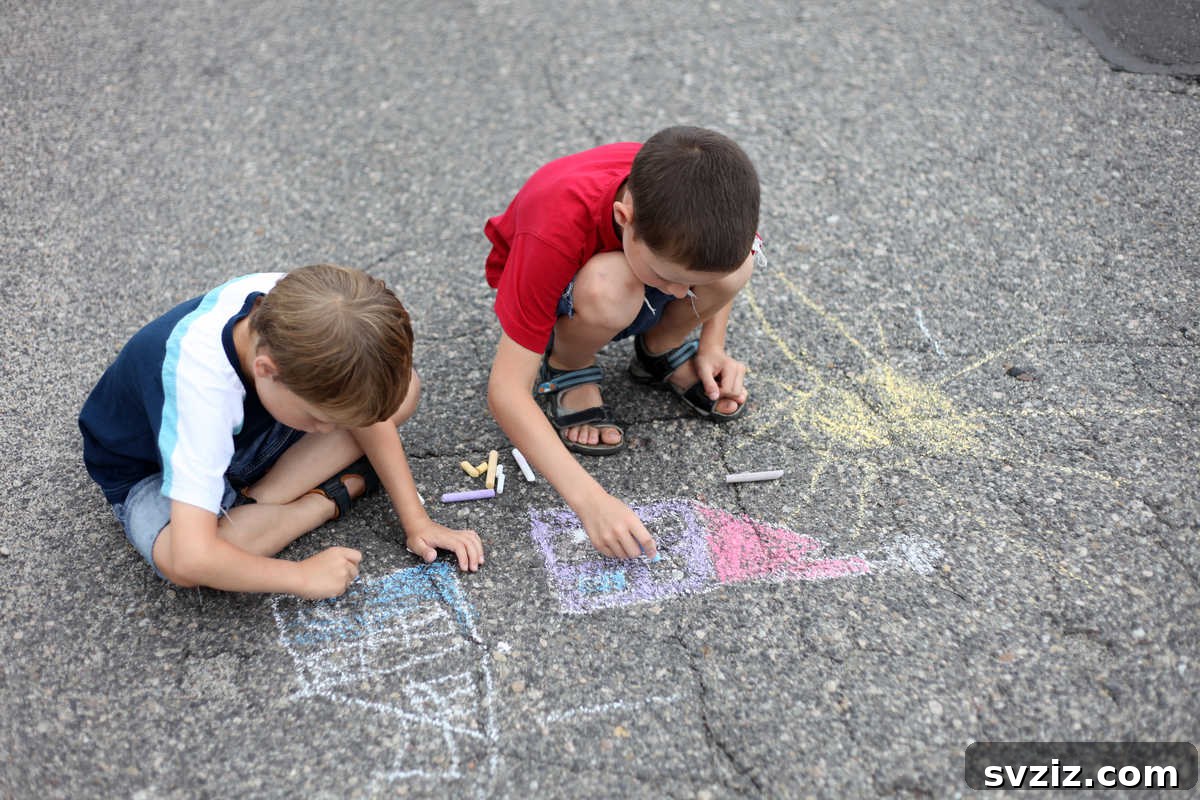 Child drawing colorful designs with sidewalk chalk on a paved surface, expressing artistic creativity outdoors.