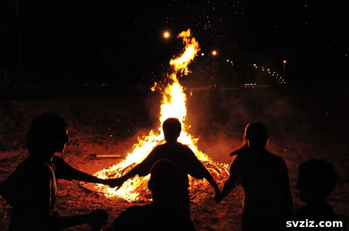 Family gathered around a safe bonfire at dusk, enjoying the warmth and atmosphere outdoors.