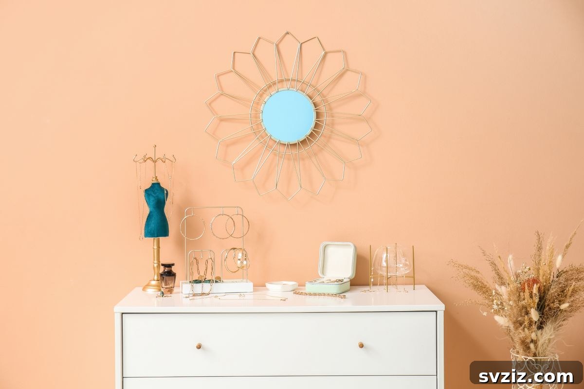 A stylish wall mirror with a decorative frame, reflecting light and making a small dorm room appear larger and brighter.