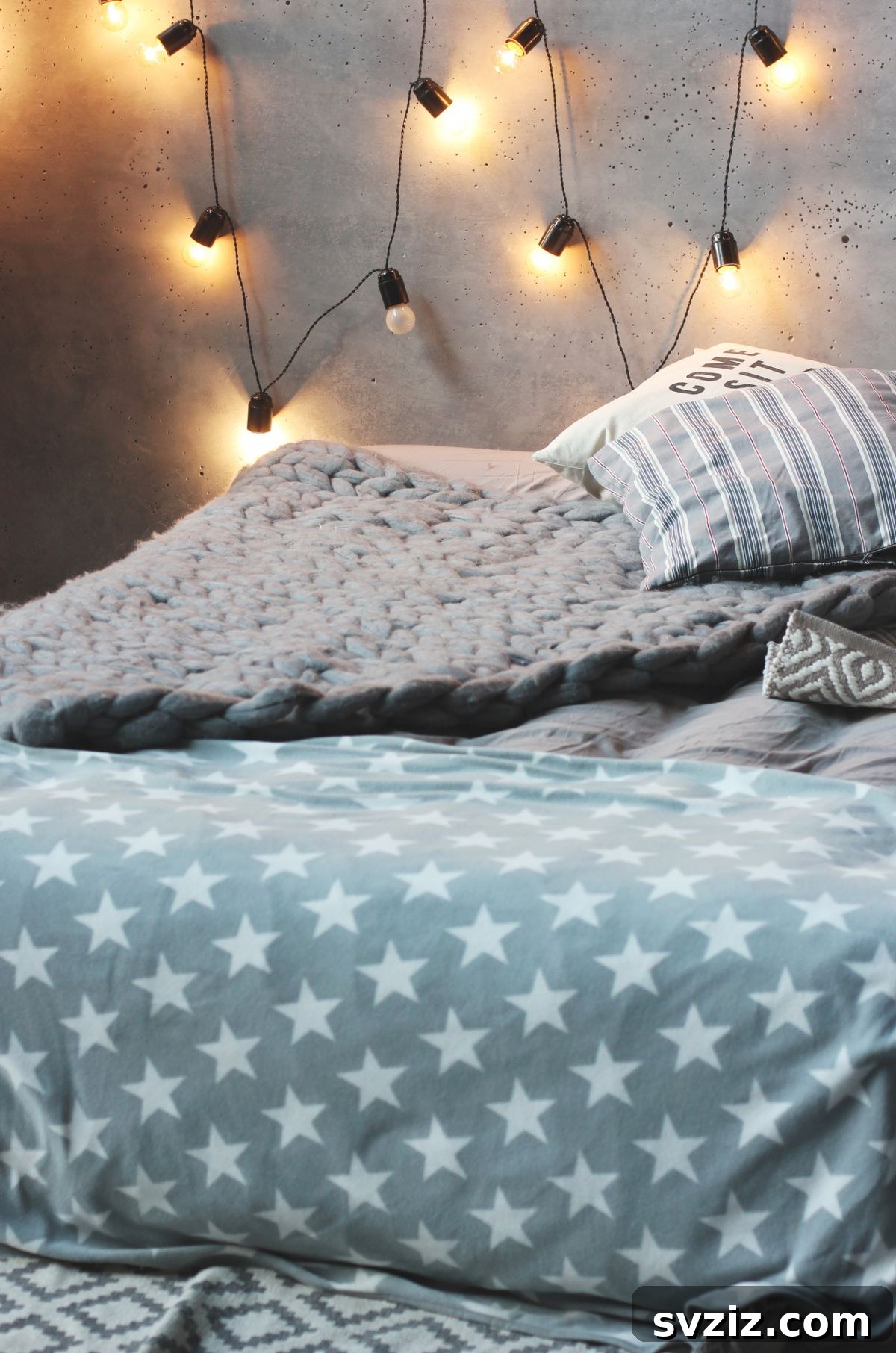 A cozy dorm room dimly lit by decorative hanging string lights, providing a soft glow and comforting ambiance.