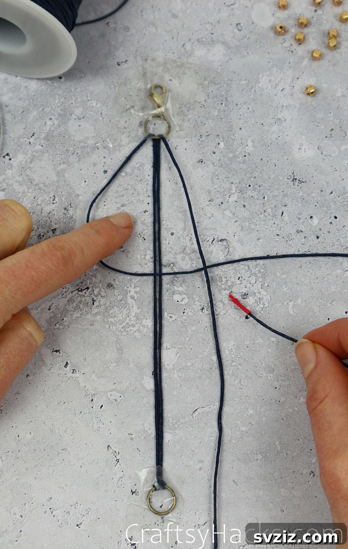 holding taped end of cord