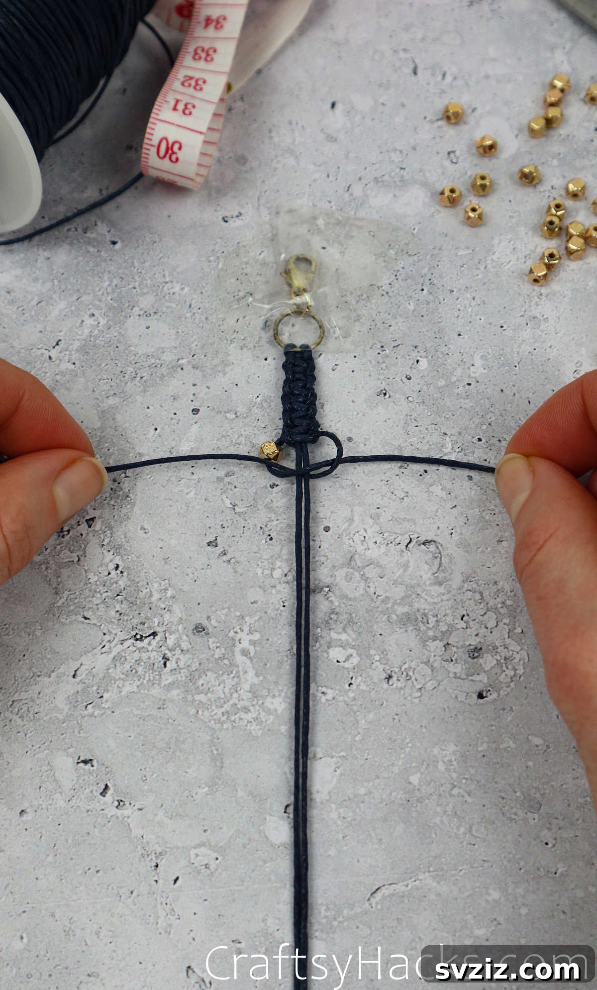 tying bead onto bracelet