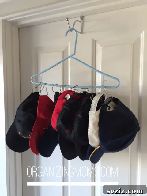 DIY baseball cap organizer made from a hanger and Dollar Tree shower curtain rings
