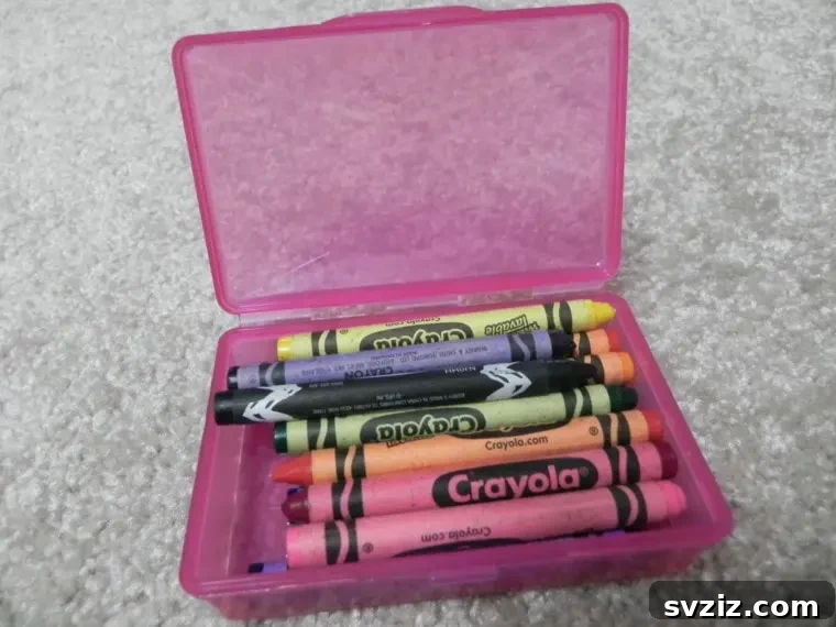 Small craft supplies like crayons stored in a repurposed Dollar Tree soap box