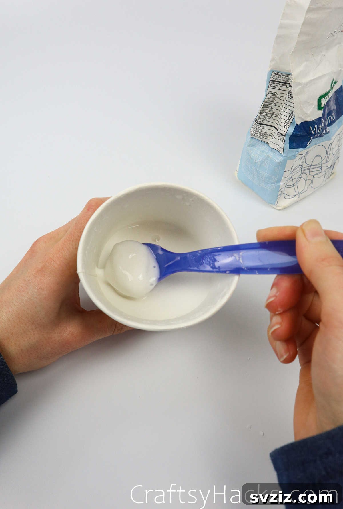 Craft Your Calming Stress Ball 11 Close-up of the water and flour mixture in a cup, showing a smooth paste