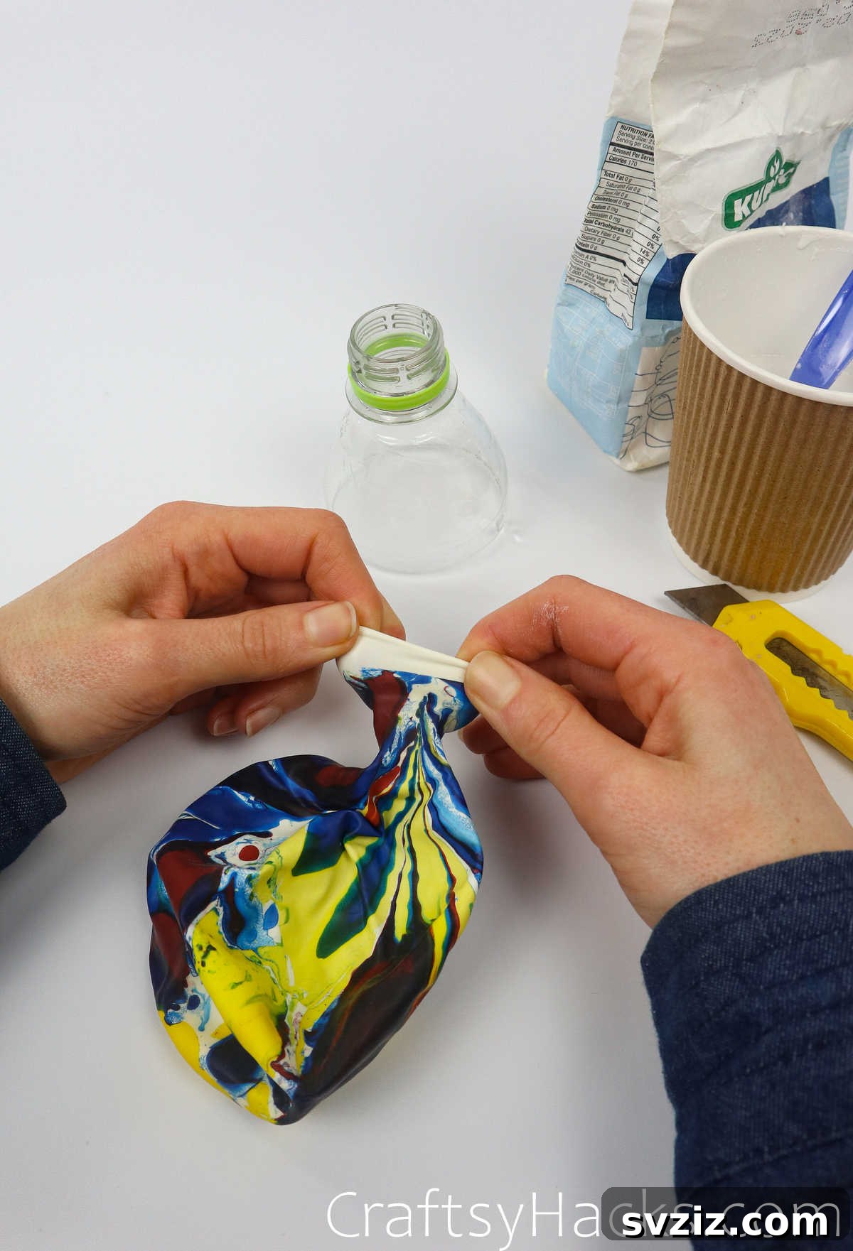 Craft Your Calming Stress Ball 17 Hand stretching the opening of a balloon