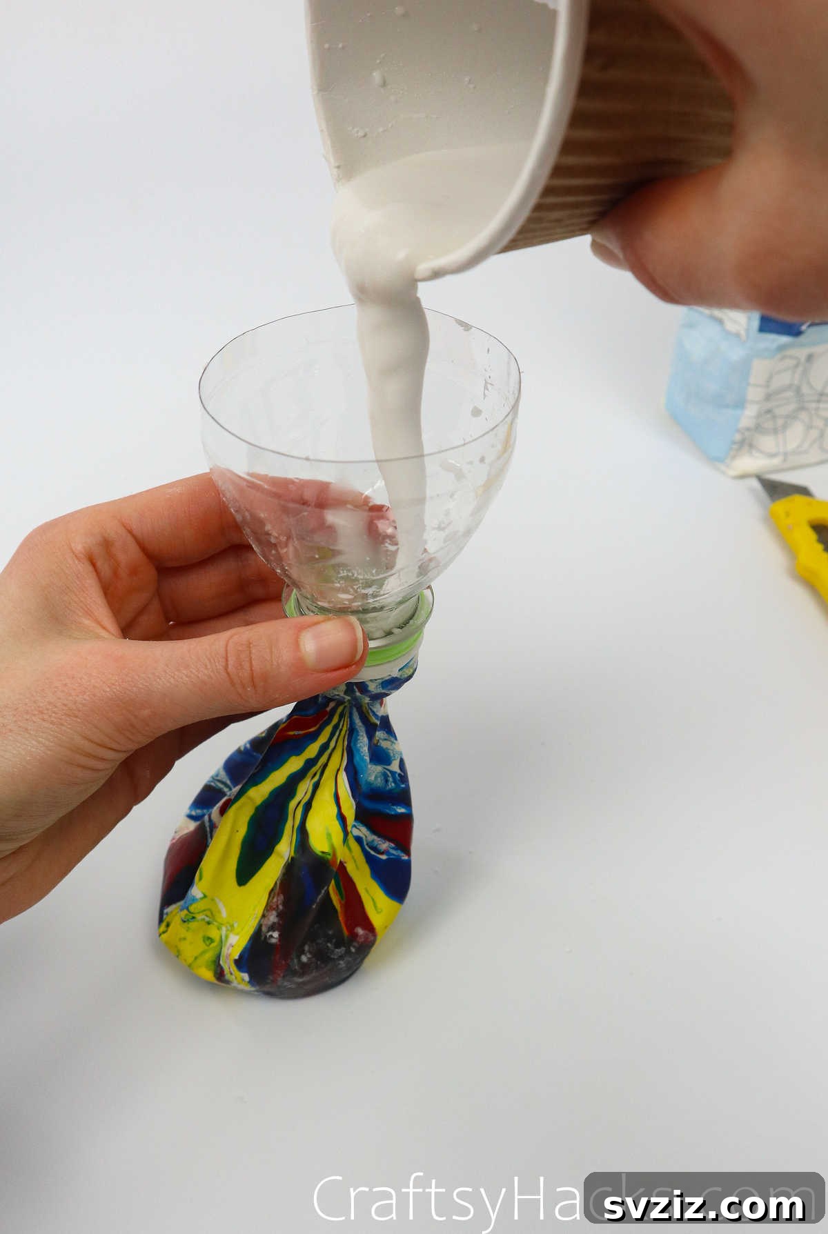 Craft Your Calming Stress Ball 19 Pouring the flour mixture into the balloon through the bottle funnel