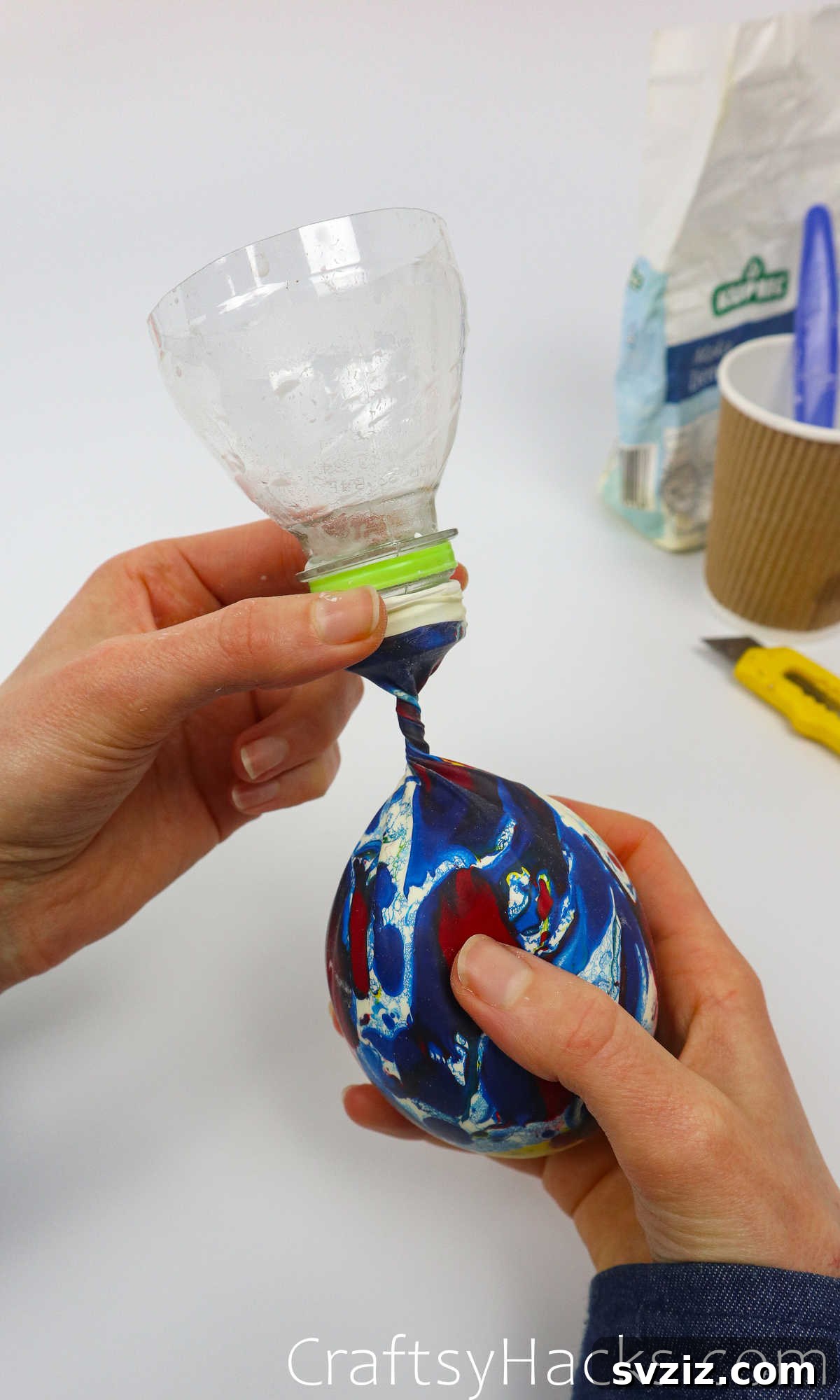 Craft Your Calming Stress Ball 20 Twisting the neck of the balloon while it's still attached to the bottle, preventing spillage