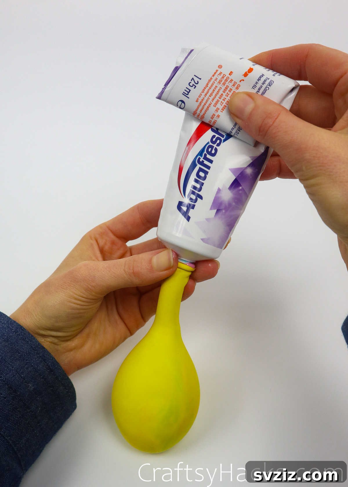 Craft Your Calming Stress Ball 26 Close-up of toothpaste being squeezed into a balloon, showing the progress
