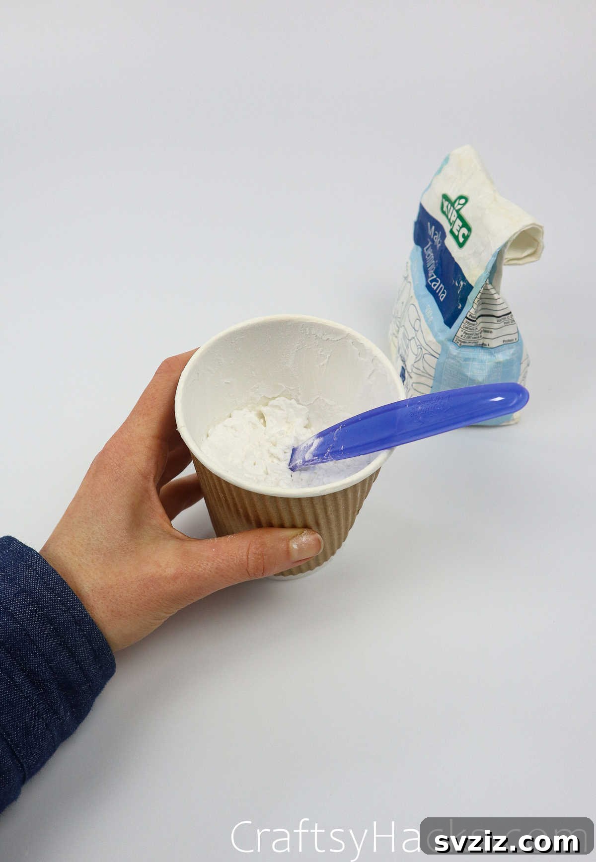 Craft Your Calming Stress Ball 9 Mixing flour with a spoon in a cup, showing the beginning of a paste