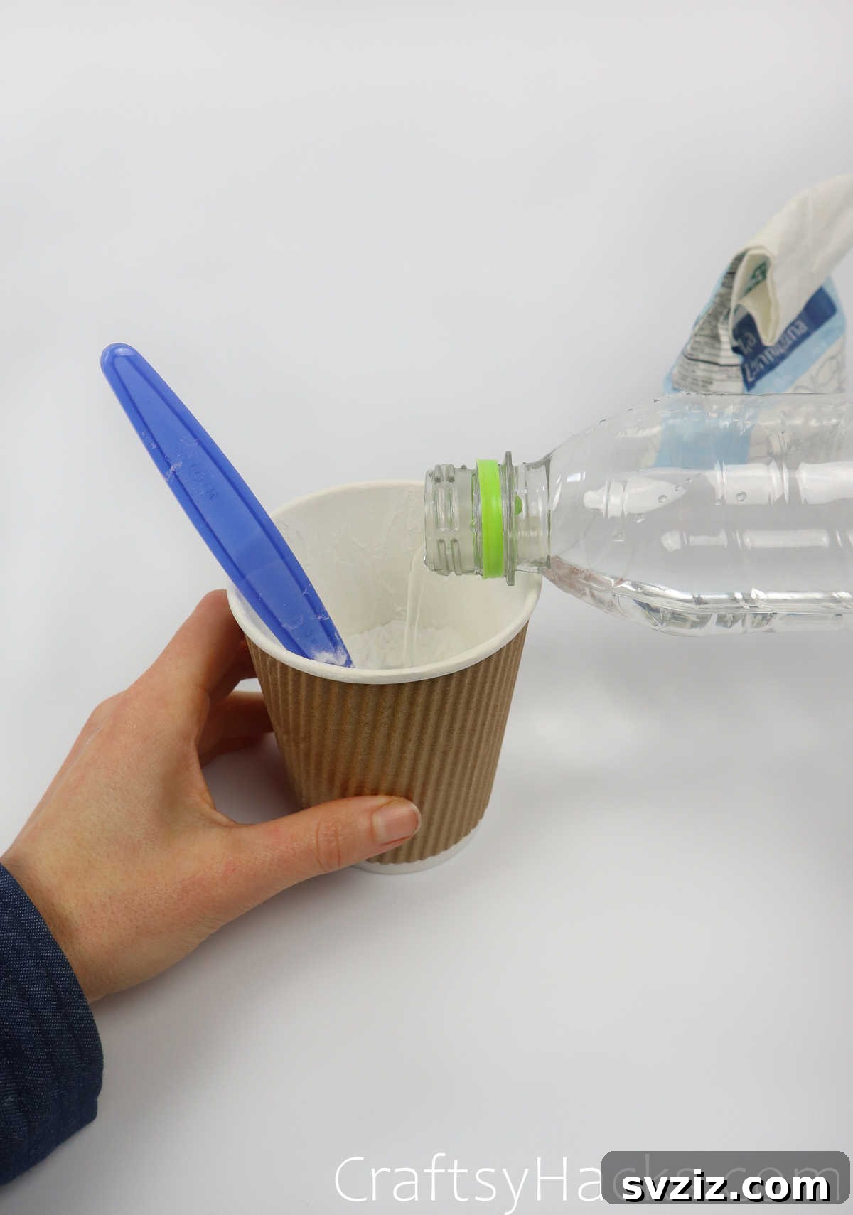 Craft Your Calming Stress Ball 10 Pouring cold water into a cup containing flour for the paste
