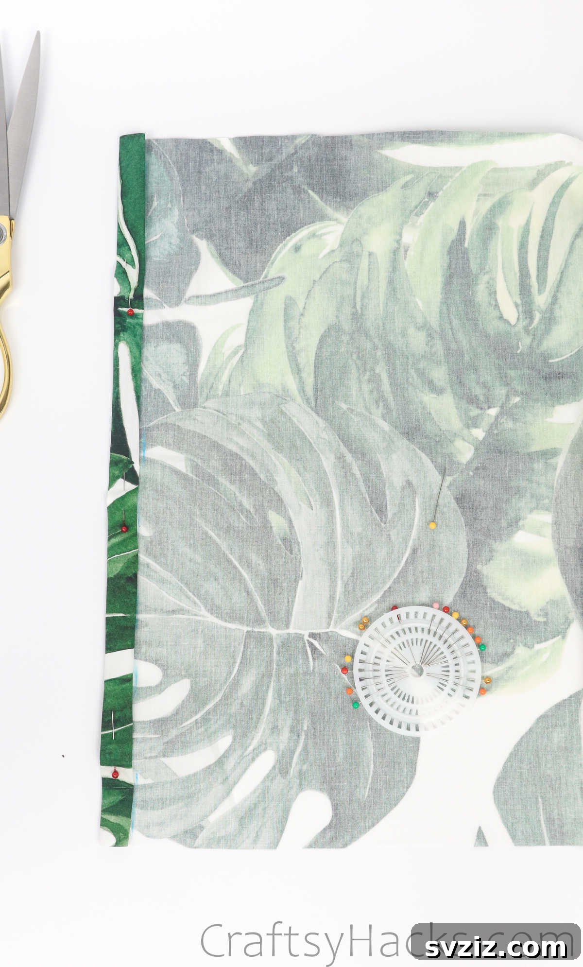 Pinning the folded fabric hem in place