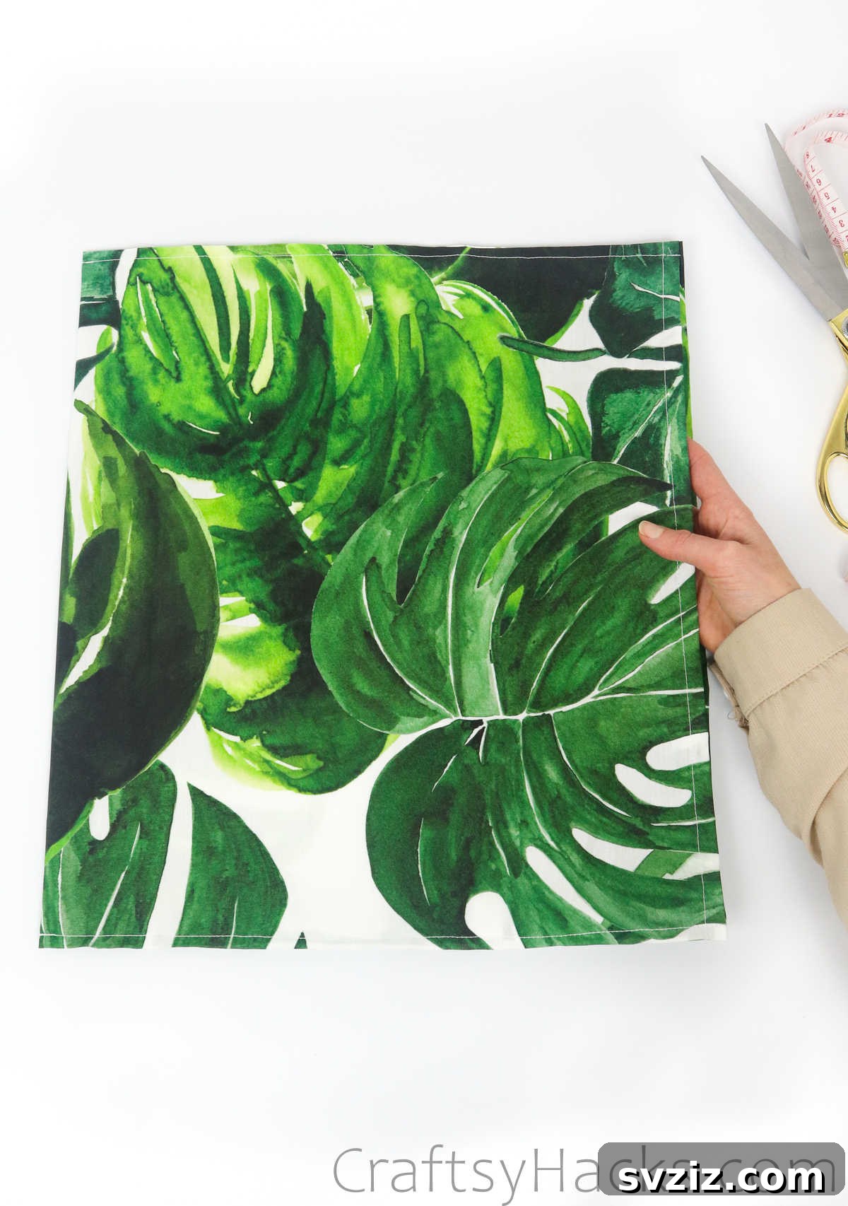 Holding the fabric, now resembling a pillowcase