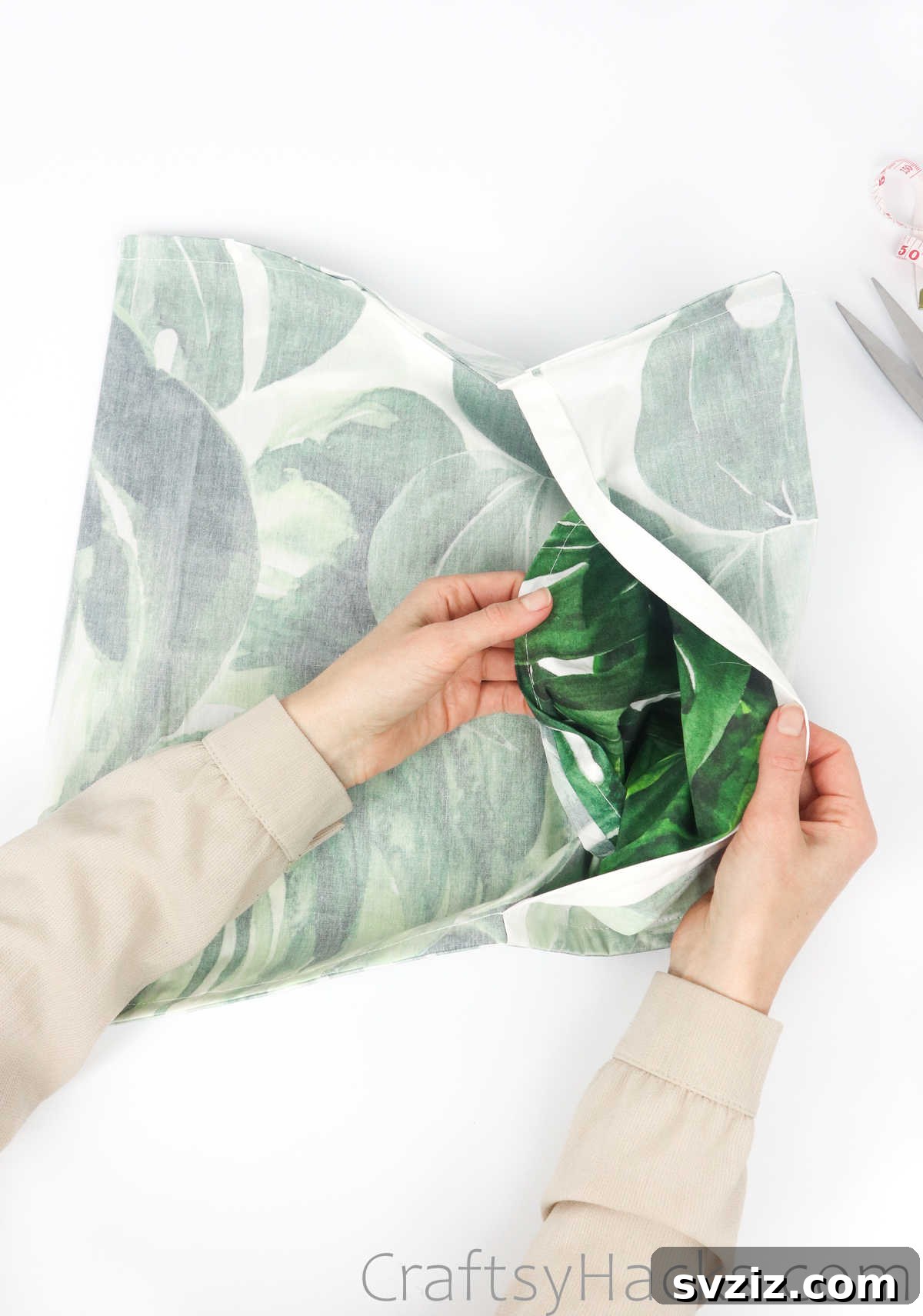 Turning the fabric inside out to reveal the finished pillowcase